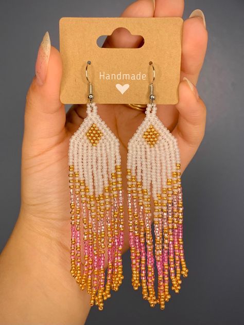 Indigenous-made beaded earrings - Indigenous Barbie inspired  Length: 3.5 in Width: 1 in Size 11 beads in: - Silver lined Pink - Silver lined Light Pink - Pearl White - Metallic Gold Clip on backings available! Just send a message or add in notes Southwestern Style Beaded White Earrings, Traditional Pink Beaded Earrings, Pink Bohemian Beaded Earrings, White Southwestern Beaded Earrings, Pink Native American Beaded Earrings, Gold Clips, Handmade Earrings Beaded, Native American Beadwork, Pink Pearl