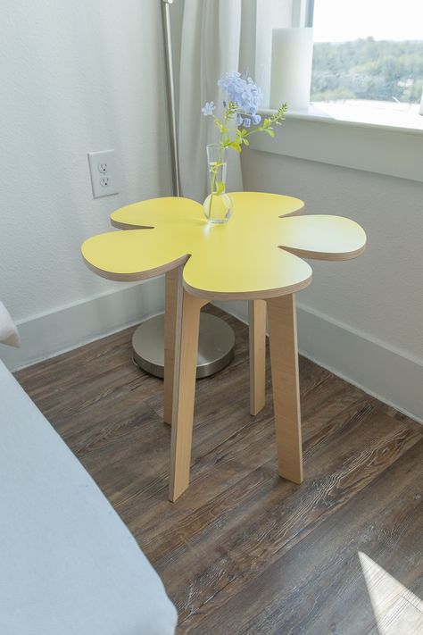 "make any room bloom with our flower power inspired collection of side tables, stools, table-top risers, coasters and even wall décor! it's flat-pack and mobile furniture so take it out on the balcony, patio, or park. all garden tabletops are designed to hang on the wall too. this flower no. 4 retro petal floral table kit includes: (1) flower no. 4 tabletop 20\" x 20\" x 1/2\" - bright yellow (1) 20\" classic modern leg-set - maple (1) olm tool to build your desk with (olm = orbit locking mechan Curvy Furniture & Decor, How To Build End Tables, Fun End Tables, Furniture Inspo Aesthetic, Aesthetic End Table, Unusual Room Decor, Strawberry Side Table, Flower End Table, Maximalist Side Table