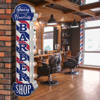 Dress up your personal salon or barbershop with some vintage-inspired wall decor like this double-sided LED marquee sign fashioned to resemble a retro barbershop sign. Made from galvanized metal with the classic red, white, and blue stripes iconically found on old barbershop signs printed on top, this piece isn't just a flashy decor accessory, it's functional too. Equipped with five LED light bulbs, this light-up sign makes for a catchy piece of wall decor as well as a fun novelty lighting optio Barbershop Sign, Barber Shop Vintage, Barber Shop Pole, Vintage Inspired Wall Decor, Barber Shop Sign, Barber Shop Interior, Barbershop Design, Backlit Signs, Barber Shop Decor