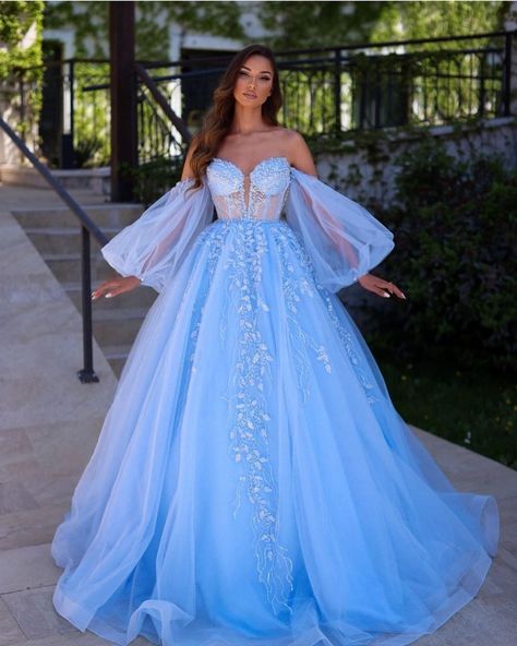 The cascading blue gown with intricate embroidery work and a gorgeous off-shoulder bodice design. If you want to make a lasting impression for your wedding festivities, this is the right pick of gown for you. #gown #gowndesign Gothic Ballgown, Blue Lace Prom Dress, Blue Sparkly Dress, Wedding Party Robes, Puffy Long Sleeves, Prom Dresses 2023, Lace Prom Dresses, Corset Dress Prom, Floral Gown