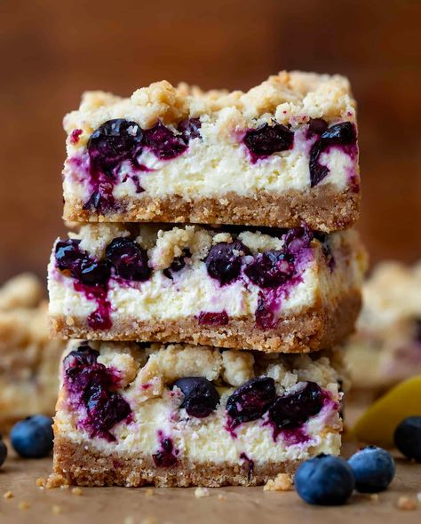 Blueberry Lemon Cheesecake Bars are a graham cracker crust with a creamy lemon cheesecake filling, fresh blueberries, and a crumble topping. Blueberry Cream Cheese Crumble Bars, Summer Christmas Desserts, Blueberry Cheesecake Tart, Blueberry Cheesecake Crumble, Fruit Brownies, Blueberry Crumble Cheesecake, Lemon Blueberry Cheesecake Bars, Lemon Cheesecake Filling, Blueberry Lemon Cheesecake