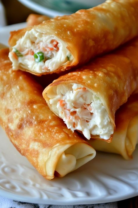 Crab Rangoon Egg Rolls are a delightful treat that will tantalize your tastebuds! Wrapped in crispy wonton skins, these egg rolls are stuffed with a creamy crabmeat filling, offering a creative spin on the classic crab rangoon. These egg rolls are packed with fresh crab meat, cream cheese, and a carefully chosen mix of spices, Crab Ragoons Eggrolls, Crabcake Eggrolls, Crab Wonton Recipes, Crab Egg Rolls Recipes, Salmon Egg Rolls, Spring Roll Filling Ideas, Wonton Appetizer Recipes, Crab Rangoon Egg Rolls, Eggroll Recipe