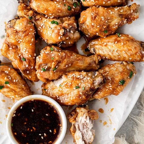 These oven baked honey garlic chicken wings are perfectly tender and crispy, coated in a sweet, sticky and addictingly good honey garlic sauce. These wings are a super simple appetiser to make for a party or Friday night footy and are sure to have people coming back for more! Sticky Baked Chicken Wings, Baked Honey Garlic Chicken Wings, Wings Oven Baked, Chicken Wings Oven, Wings Oven, Ranch Chicken Wings, Garlic Chicken Wings Recipe, Honey Garlic Wings, Baked Honey Garlic Chicken