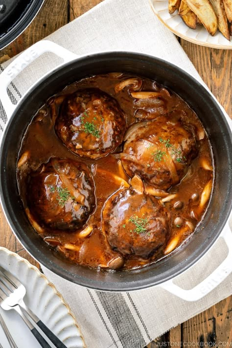 Japanese Stewed Hamburger Steak called Nikomi Hambagu is made with seared beef and pork patties cooked in a delicious wine-reduction gravy sauce along with mushrooms and onions, with an optional melted cheese on top. This Western-style Japanese hamburger steak is juicy, tender, and full of bold complex flavors. #hambagu #hamburgersteak | Easy Japanese Recipes at JustOneCookbook.com Easy Beef Tips, Japanese Hamburger Steak, Japanese Cookbook, Japanese Hamburger, Beef Tips Recipe, Pork Patties, Brazilian Steak, Hamburger Potato Casserole, Just One Cookbook