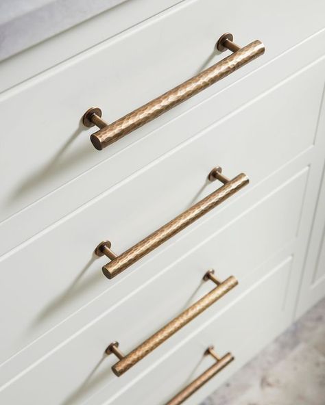 A cream cabinet with the Alexander and Wilks Hammered Leila Pull Handles Champagne Bronze Kitchen Faucet, Champagne Bronze Kitchen Hardware, Champagne Bronze Bathroom, Bronze Kitchen Hardware, Champagne Bronze Kitchen, Farmhouse Drawer Pulls, Gold Kitchen Hardware, Delta Champagne Bronze, Bronze Kitchen Faucet