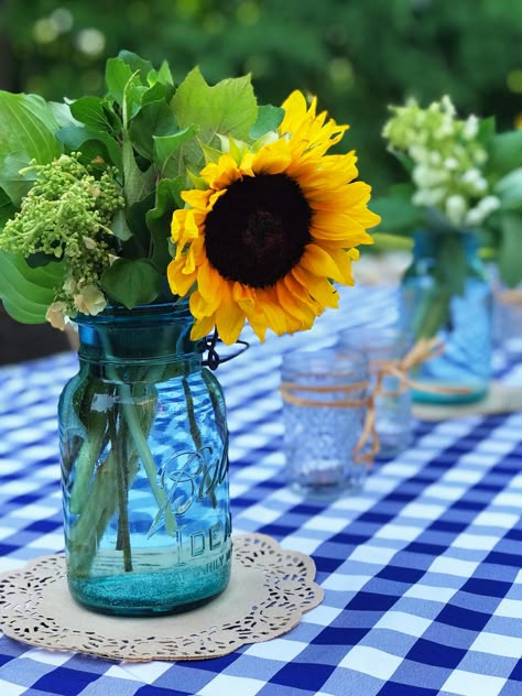 Gingham tablecloth, blue green mason jar and sunflowers Bbq Party Decorations, Backyard Party Decorations, Backyard Bbq Party, Sunflower Centerpieces, I Do Bbq, Bbq Wedding, Baby Shower Bbq, Mason Jar Centerpieces, Blue Checkered