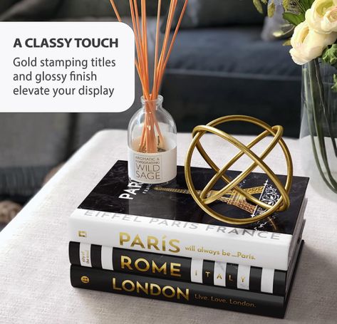 Travel-themed BLANK Books — Bring a stylish and decorative feel to any room. Inspired by Eiffel Tower facelift to gold hue. Cover design with the 3 most visited cities: Paris, London and Rome. This books stack portrait your interest to travel! Classy Touch Gold Foil — Luxurious Gold stamped spine on Glossy Hardbacks. The eye-catching striped spine paired well with the other books. Black and white colors work perfectly with almost every living room decor. Entryway Bookshelf, Fake Books Decor, Books For Decoration, Coffee Table Books Decor, Blank Books, Black Living Room Decor, Room Inspired, Table Entryway, Books Decor