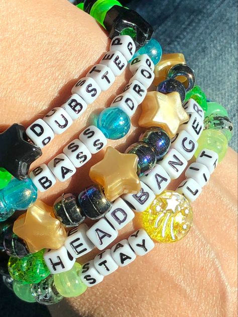 5 Dubstep themed Kandi beaded bracelets You will receive these exact bracelets *Dubstep *Headbanger *Stay Lit *Bass Drop *Pearly Gold Stars & Black Iridescent We make our Kandi bracelets using stretch string Available Sizes: OSFM 5 - 5.5 inches 5.5 - 6 inches 6 - 6.5 inches 6.5 - 7 inches 7 - 7.5 inches 7.5 - 8 inches 8 - 8.5 inches 8.5 - 9 inches Please send us a message to let us know what size bracelets you need. If you need a size not listed please contact us and we’ll be happy Lgbtq Kandi Bracelets, Festival Bracelet Ideas, Clay Beads Patterns, Candy Bracelet Ideas Rave, Kandy Ideas Rave, Candy Bracelets Rave, Single Kandi Bracelets, Edc Kandi Ideas, Rave Candy Ideas