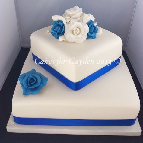 2 tier square ivory and royal blues wedding cake with hand made sugar roses Royal Blue Wedding Cake 2 Tier, Light Blue Wedding Cake, Royal Blue Wedding Cakes, Royal Blue Cake, Square Cake Design, 2 Tier Wedding Cakes, Green Wedding Decorations, Beach Theme Wedding Cakes, Square Wedding Cakes