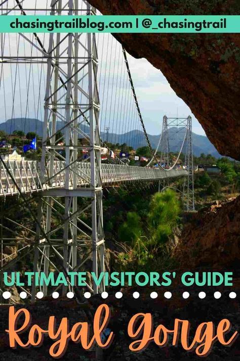 The Royal Gorge Bridge as seen through a rock formation and several words: chasingtrailblog.com and @_chasingtrail in a green rectangle and "ultimate visitors' guide Royal Gorge" Royal Gorge Bridge Colorado, Royal George Train Colorado, Royal Gorge Colorado Train, Royal Gorge Train, Denver Colorado Vacation, Royal Gorge Colorado, Wyoming Trip, Royal Gorge Bridge, Denver Trip