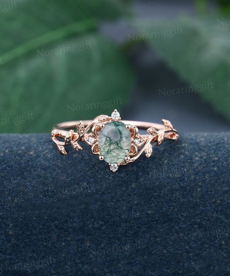 Oval cut Moss Agate engagement ring Unique rose gold Moissanite ring flower ring Dainty Leaf Marriage ring Delicate promise ring Bridal ring -----Ring Information----- +Center stone: 6*8 mm Moss Agate +Cut type: Oval cut +Side Stone:  Natural Diamonds or Moissanite Approx weight: 0.05 ctw Metal : Solid 14k/18k yellow gold white gold or rose gold, other metal or gemstones, please contact me! Click on the "Pin It" icon if you like this item, Thanks so much! Ring Size All rings are standard CA/US s Mossy Engagement Ring, Cottagecore Rings Engagement, Moss Agate Engagement Ring Gold, Engagement Rings Leaves, Cottagecore Engagement Ring, Moss Engagement Ring, Earthy Engagement Rings, Moss Agate Engagement Rings, Agate Wedding Ring