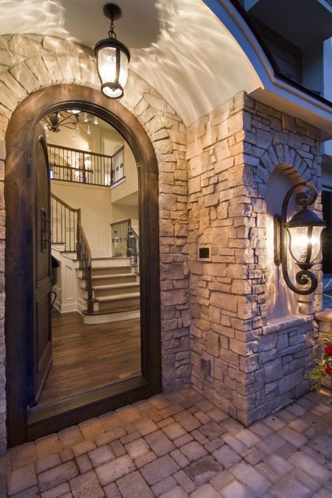 pretty entry Stone Entryway, Arched Front Door, French Country Exterior, Foyer Lighting Fixtures, Entry Design, Foyer Lighting, Arched Doors, Entry Way Design, Stone Walls