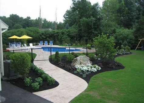 Landscaping around pool Pool Fencing Landscaping, Pretty Pool, Landscaping Around Pool, Pool Fences, Pool Plants, Inground Pool Landscaping, Landscaping Around House, Pool Fencing, Living Pool