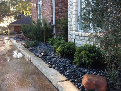 Here we used river rock instead of mulch. Makes for a dramatic look accented by boulders. Diy Rock Landscaping Ideas, Black Rock Landscaping, Landscaping Garden Ideas, Black River Rock, River Rock Garden, River Rock Landscaping, Stone Landscaping, Rock Landscaping, Meadow Garden