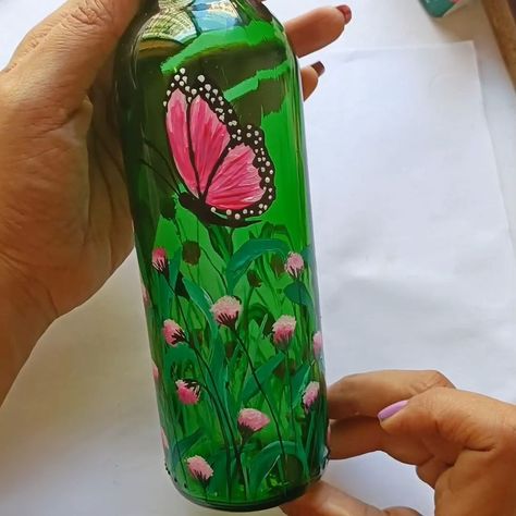 Butterfly Painting on Glass Bottle | brush, butterflies, glass bottle | Butterfly Painting on Glass Bottle Materials Used: Brushes: Flat brush size 4, Long brush size 4, Fuzzy brush Acrylic Paints: White, Pink, Green, Dark... | By Little Rocks Green Glass Bottle Painting, Butterfly Acrylic Painting, Painted Glass Bottles, Painting On Glass, Green Glass Bottles, Green Bottle, Flat Brush, Butterfly Painting, Wine Bottle Crafts