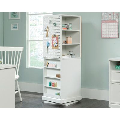 Never feel unorganized while crafting again - this craft tower from the Craft Pro Series has got you covered. Its swivel base allows it to easily spin and turn so you can access the storage spaces on any of the four sides. This versatile, swiveling craft tower includes a pegboard back and a corkboard panelkeeping things organized and easy to reach for when you need them. Two storage drawers with full extension slides offer hidden storage for supplies like yarn, paper, and more. This craft supply Craft Room Island Work Spaces, Tiny Craft Room, Storage For Art Supplies, Craft Tower, Quilt Room Organization, Pegboard Craft Room, Office Craft Room Combo, Ikea Skadis, Sewing Room Furniture