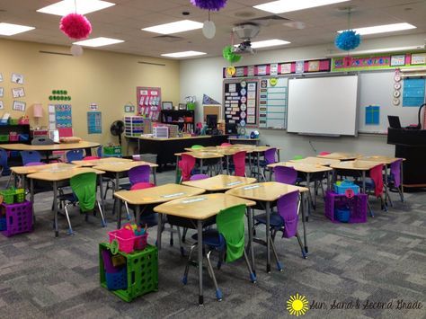 I love this cute and bright second grade classrooms!  Love the file crates to with each table's supply caddy and folders! Classroom Table Storage, Classroom Organization High School, Seat Sacks, Classroom Seating Arrangements, Classroom Decor Middle, Classroom Arrangement, Colorful Classroom, Nice Room, 21st Century Classroom