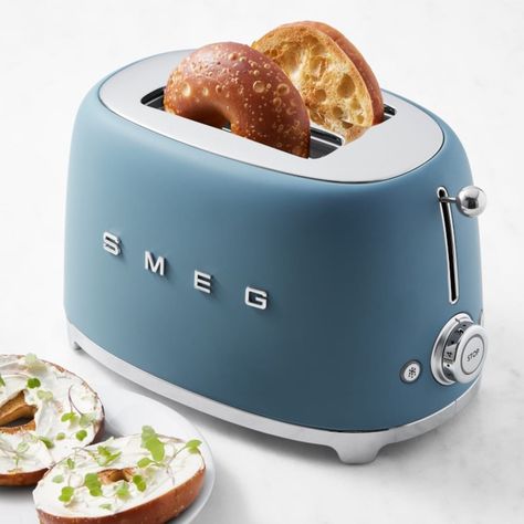 Italian-based SMEG is known for its '50s retro-look appliances designed in collaboration with some of the world's top architects. This toaster combines iconic midcentury style with modern features, so you can count on perfect toast or bagels every time. Choose from a selection of luscious colors that match other SMEG appliances for a coordinated collection. Two extra-wide slots. Six browning levels offer precise control of browning. Backlit chrome knob with four functions: Reheat, Defrost, Cance Retro Toaster Oven, Aesthetic Toaster, Smeg Espresso Machine, Rosh Hashanah Menu, Smeg Toaster, Vintage Toaster, Rainbow Kitchen, Smeg Appliances, Halloween Menu