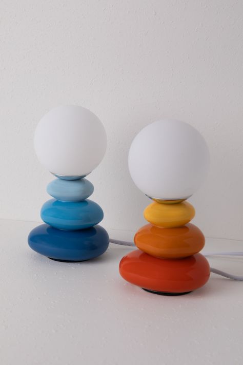 Illuminate your space with our Mako table lamp. Perfect for your nightstand or desk, this little lamp features different colored ceramics imitating stacked stones. Topped with a frosted glass globe which emits a warm light. A designer-friendly statement piece and table lamp all-in-one. Features- Bulb included- Plug in- Frosted Glass Globe- In-line switch Content + Care- Glass & Ceramic- Wipe Clean- Imported Size- Dimensions: 4.72" W x 8.27" H- Weight: 1.4lbs- Shipping package dimensions: 7"L x 6 Dopamine Design, Little Lamp, Stacked Stones, Nyc Apt, Colorful Lamps, Wall Decor Lights, Baby Greeting Cards, Stacked Stone, Diy Home Decor Easy