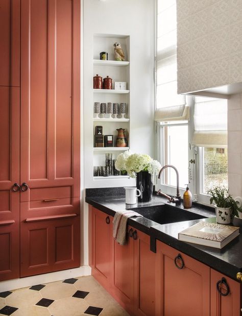 White is all right, but salmon is slammin'. French design firm D.Mesure made a one-of-a-kind choice with these brick-red cabinets and speckled black marble countertops. When opting... Red Kitchen Cabinets, Terracotta Kitchen, Kitchen Niche, Red Cabinets, Colorful Kitchen Decor, Black Countertops, Orange Kitchen, Red Kitchen, Kitchen Color