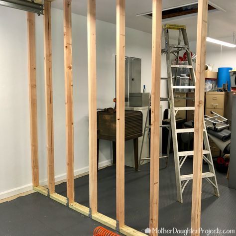 How to Build a Garage Storage Wall - Mother Daughter Projects Diy Garage Closet, Storage Room In Garage, Garage Wall Divider Ideas, Garage Wall Divider, Garage Storage Concrete Walls, Temporary Wall In Garage, Garage Separation Wall, Garage Room Divider Ideas, Garage Divider Wall