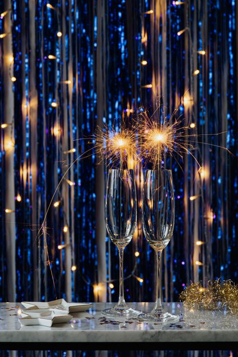 New years eve, cold fires in glasses on a blue background New Years Eve Backdrop Ideas, New Year’s Eve Background, New Years Colors, New Years Eve Background, New Year Home Decor Ideas, New Years Backdrop, New Year's Eve Backdrop, New Years Ideas, New Year's Eve Background