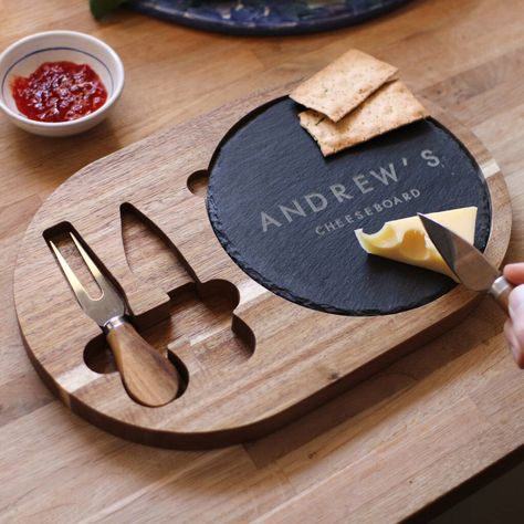 A wooden cheese board and knife set with a grey slate insert, laser-engraved with the recipient's name. For the dinner party host who appreciates the finer things (and finer cheeses!) in life, this wooden cheese board and carved knife set is a wonderful, bespoke kitchen gift. We personalise the grey slate insert with your loved one's name to make it truly their own.Each set includes a cheese knife and a cheese fork; which can also be laser-engraved for an extra cost. Our examples feature named c Kitchenware Ideas, Slate Wedding, Custom Cheese Board, Slate Cheese Board, Wooden Kitchenware, Wooden Tie, Personalized Cheese Board, Grey Slate, Wood Cheese Board