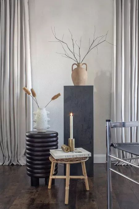 minimalist home decor, stool, terracotta vase, stone vase, home decor book, candle holder, candle, branches, dried flowers, drapes, curtains Walmart Home Decor, Minimalist Home Office, Terracotta Vase, Walmart Home, Vase Home Decor, Stone Vase, Target Home Decor, Amazon Home Decor, Minimalist Room