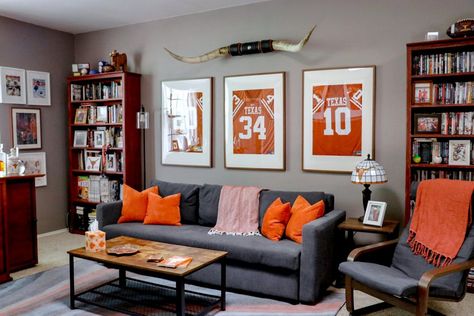 Sports Themed Family Room, Sports Room Decor Man Caves, Man Cave Spare Bedroom, Tasteful Sports Decor Man Cave, Classy Sports Decor, Man Cave Gallery Wall, Man Cave Living Room Ideas, Men’s Decor Ideas, Basement Sports Decor