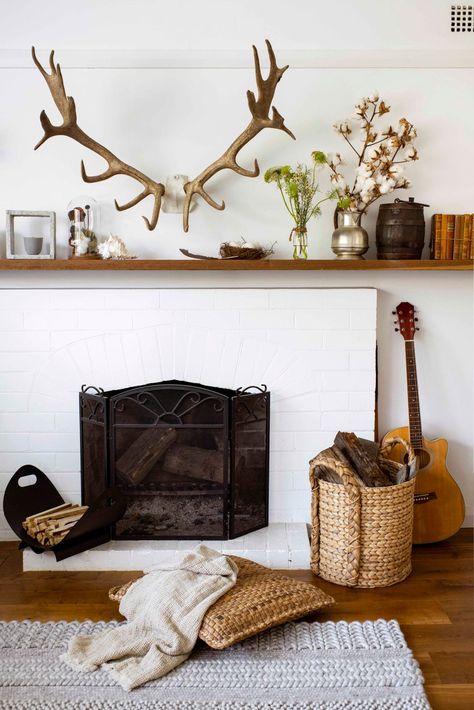 An earthy and eclectic cottage on Sydney's North Shore Antlers Over Fireplace, Brick Hearth, Timber Gates, Brick Look Tile, Antlers Decor, Aged Mirror, Eclectic Cottage, Red Bluff, Orange Chair