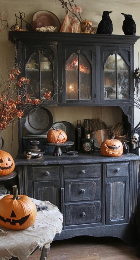 Elevate your kitchen with sophisticated Gothic Halloween decor. Opt for a color palette of black, silver, and deep red. Display elegant candelabras with black tapered candles on the countertop. Hang ornate silver frames with Victorian-inspired Halloween prints. Add drama with a black lace table runner on the island. Place crystal decanters filled with deep red liquid on open shelves. This Halloween kitchen decor creates a luxurious and slightly sinister atmosphere perfect for upscale Halloween g Dark Cottagecore Halloween, Victorian Halloween Aesthetic, Gothic Christmas Decor, Gothic Chic Decor, Goth Kitchen Ideas, Dark Halloween Decor, Spooky Cottagecore, Gothic Halloween Decor, Crystal Decanters