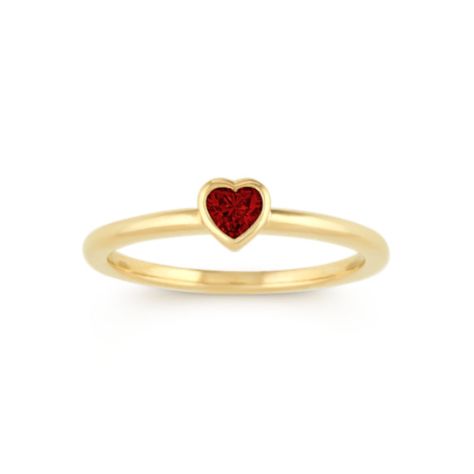 A single vibrant heart-shaped natural ruby  at approximately .18 carat total gem weight  is the focal point in this lovely stackable ring. Crafted of quality 14 karat yellow gold  the bezel-set design measures 4.8mm wide and is part of our Limited Collection. Heart Shaped Ruby Ring, Ruby Heart Ring, Favorite Engagement Rings, Ring Heart, Ring Bezel, Bezel Ring, Platinum Jewelry, Heart Shaped Diamond, Set Ring