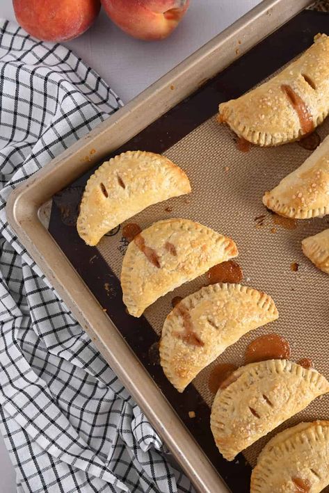 Peach hand pies are the ultimate late summer dessert. With a buttery pie crust, filling made with summer-ripe fresh peaches, and crunchy sugar on top, these are hand-held gems of peach pie goodness. Hand Held Peach Pies, Peach Hand Pies Recipes, Peach Hand Pies With Fresh Peaches, Hand Pie Dough Recipe, Hand Pie Crust, Hand Pies Dough Recipes, Handheld Pies, Fruit Hand Pies, Peach Hand Pies