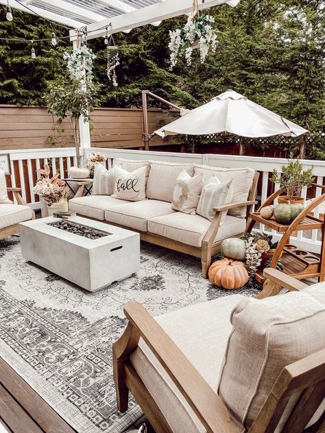 Create a cozy fall deck or patio in your backyard outdoor living space with cozy cottage style neutral beige sand color linen and wood outdoor furniture, a charcoal grey vintage floral farmhouse outdoor area rug from Boutique Rugs, a propane fire pit / concrete gas firepit, fairytale pumpkins and rustic earthy faux fall floral stems. - Rain and Pine #fallfarmhousedecor #falldecor #outdoorliving #backyard #patiodecor #cottagedecor #farmhousedecor #cozydecor #neutraldecor #fallpatiodecor Fairytale Pumpkins, Fall Patio Decor, Fall Deck, Fall Patio, Floral Farmhouse, Boutique Rugs, Outdoor Fire Pit Table, Rectangular Fire Pit, Farmhouse Outdoor