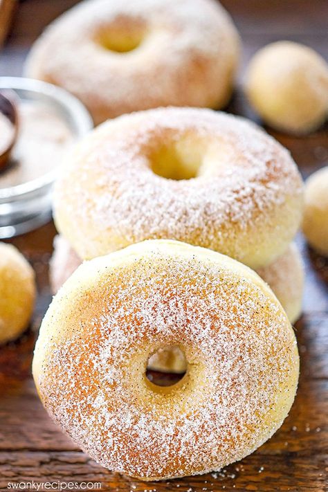 A cinnamon sugar air fryer donut on a wooden board. Dusted in cinnamon sugar with other donuts behind it. Air Fryer Donuts Biscuits, Air Fryer Donut Recipes, Best Donut Recipe, Deep Fried Donuts, Air Fryer Donuts, Raised Donuts, Making Donuts, Fried Donuts, Donut Recipe