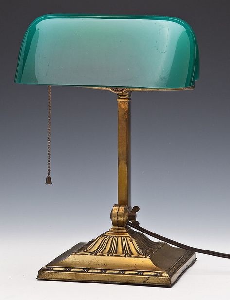 AN ART DECO EMERALITE DESK LAMP, H.G. FADDIN & CO, NEW YORK, USA 1916 The green glass shades used for the Emeralite lamps were produced by a Czech company, J. Schreiber & Neffen, or S&N as they were called by McFaddin. Though they produced glassware for a number of customers, their contract with H. G. McFaddin & Co. permitted them to produce those unique green shades only for the Emeralite lamps. Bankers Lamp, Lamp Art, Glass Nail, Green Shades, Glass Nails, Lamps Plus, S N, Green Glass, Shades Of Green