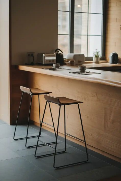 Two wooden bar stools at a kitchen counter with coffee cups and small appliances. Kitchen Breakfast Bar Stools, Contemporary Dining Room Furniture, Breakfast Stools, Pub Tables, Breakfast Bar Stools, Breakfast Bar Kitchen, Kitchen Island With Seating, Compact Kitchen, Counter Height Table