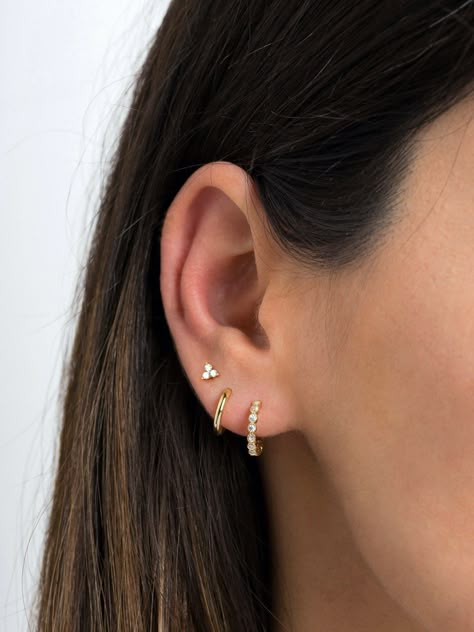 "Dainty and beautiful, these tiny studs are adorned with three bright prong-set cubic zirconia gemstones. An everyday staple piece, perfect for wearing in a first, second or third earhole or on a cartilage piercing for a dainty addition to your look. * Sold as a PAIR * D E T A I L S * ∙ Material: .925 Sterling Silver or 18K Gold Plated over .925 Sterling Silver ∙ Stone: White Zirconia ∙ Dimensions: 4mm ∙ Hypoallergenic & nickel-free * P A C K A G I N G * ∙ All jewelry is sent out beautifully Three Ears Pierced, Three Hole Ear Piercing Earrings, 3 Earrings Piercing In A Row, Third Stud Earrings, Earrings Three Holes, 3 Earrings Piercing Ideas, 3 Ear Piercings Gold, Ear Piercings 3, Gold Earrings Three Holes