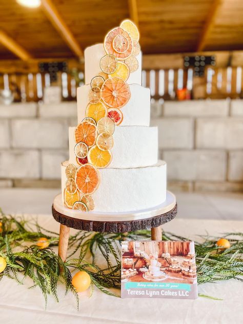 Tiered wedding cake with dried citrus fruit for a springtime wedding. Wedding Cake Dried Fruit, Passionfruit Wedding Cake, Wedding Cake With Oranges, Orange Slice Wedding Cake, Dried Citrus Decorations Wedding, Dried Fruit Cake Decoration, Citrus Decorated Cake, August Wedding Cake, Dried Fruit Wedding Cake