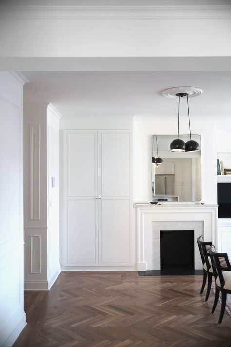 "Though a working fireplace was not permitted by the building, Space Exploration added a new faux fireplace. The hearth and firebox are absolute black granite, the hearth installed flush to the floor." Bathroom Baseboard, Walnut Wood Floors, Baseboard Styles, Baseboard Trim, Herringbone Wood Floor, Floor Molding, Walnut Floors, Herringbone Floor, Brooklyn Heights