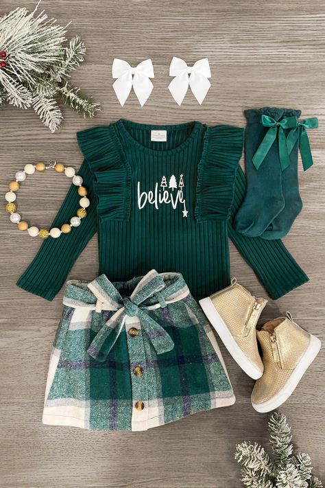 Let your little girl show off her festive style in this "Believe" Green Flannel Skirt Set. The green long sleeve top features ruffle detailing with a fun design on the front and is paired with a matching plaid skirt. Shop today! Flannel Skirt, Dress Sparkle, Sweater Skirt Set, Kids Christmas Outfits, Green Long Sleeve Top, Green Flannel, Belt Top, Skirt Belt, Green Long Sleeve