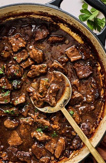 A spoon digging into the best beef tips and gravy ready to serve Easy Beef Bourguignon, Wine Gravy, Beef Tip Recipes, Red Wine Gravy, Beef Tips And Gravy, Beef Bourguignon, Dutch Oven Recipes, Beef Tips, Tender Beef