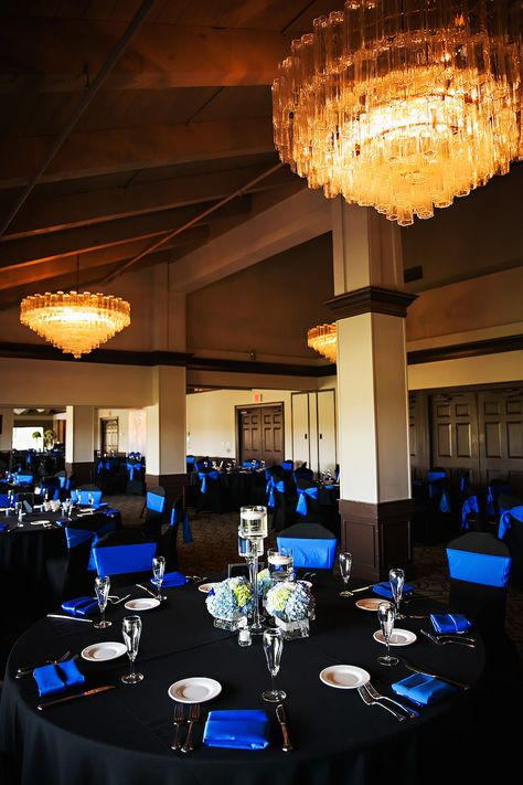 Traditional Wedding Reception Décor with Black Tablecloths, Royal Blue Chair Covers and Napkins with Blue and Ivory Hydrangea Centerpieces at Countryside Country Club Wedding Venue | Limelight Photography Blue And Black Wedding Venues, Blue And Black Table Decorations, Black And Sapphire Blue Wedding, Black N Blue Wedding, Blue Black And Silver Centerpieces, Black And Blue Table Decor, Sapphire And Black Wedding Theme, Royal Blue And Black Wedding Ideas, Royal Blue And Black Quinceanera Ideas