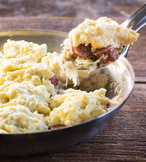 Sauerkraut and Dumplings with Kielbasa being scooped from skillet Sauerkraut And Dumplings, Dumplings And Sauerkraut, Sausage Dumplings, Kielbasa Recipe, Sauerkraut Recipe, Pork Dumplings, Bread Dumplings, Kielbasa Recipes, Homemade Sauerkraut