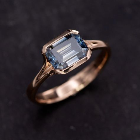 Elevate your engagement game with our stunning Emerald Cut Blue Moissanite Fold 14k Rose Gold Solitaire Ring! This ready-to-ship beauty boasts a sophisticated emerald cut grayish-blue moissanite, elegantly set in a low-profile semi-bezel. Its tasteful blend of luxury and exclusivity makes it the perfect choice to create that unforgettable moment. Tap the link in our bio to order yours now! https://nodeform.com/products/emerald-cut-blue-moissanite-fold-14k-rose-gold-solitaire-engagement-ring-s... Blue Moissanite Ring, 14k Rose Gold Solitaire Ring, Engagement Games, Rose Gold Solitaire Ring, Blue Moissanite, Grayish Blue, Gold Solitaire Ring, Stunning Engagement Ring, Greyish Blue