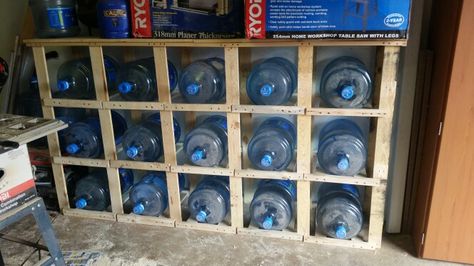 Water bottle storage completed. Yay! #breathingspace #pallets #DIY #waterbottlestorage Diy 5 Gallon Water Bottle Storage, Water Bottle Storage Rack, Barrels Diy, 5 Gallon Water Bottle, Rain Barrels, Water Bottle Storage, Pallets Diy, Rain Barrel, Filtered Water