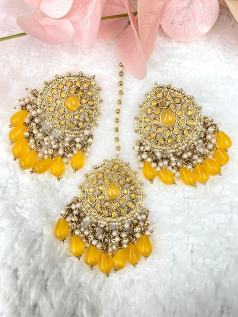 Beautiful pair of antique gold yellow pearl Indian earrings set with matching tikka  Gold base filled with beads and light antique gold stones, pearl intricate detailed beading and dangling drops Earrings are 5cm wide & 7cm length  Tikka is 5cm wide & 17cm length Make sure to follow our other collection  also don't forget to share and tag us on all social media @ zayridh Tikka Jewelry, Bollywood Party, Yellow Pearl, Asian Jewelry, Wedding Week, Desi Wedding, Indian Earrings, Yellow Earrings, Bride Clothes