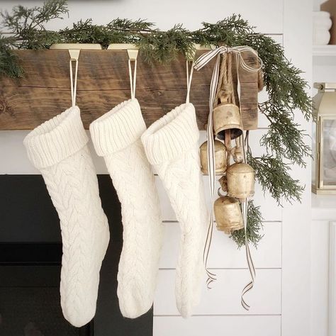 Christmas mantel with reclaimed wood beam, shiplap, harmony bells, knit stockings, and cedar garland. The Coastal Oak. Coastal Oak, Minimal Christmas, Christmas Mantel, Christmas Mantle, White Christmas Decor, Natural Christmas, Boho Christmas, Christmas Mantels, Farmhouse Christmas Decor