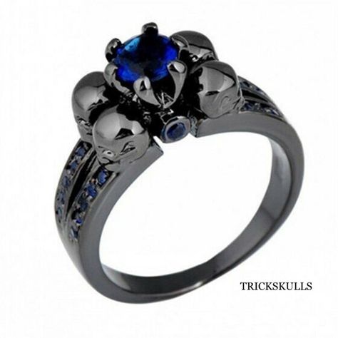 Four Skull Black Anodized Blue Cubic Zirconia Gothic Metal Punk Ring This Elegantly Detailed Blue Cubic Zirconia Ring Is Highlighted By Blue Rhinestones Along The Side Of The Ring And Four Skulls Around The Main Setting. The Ring Core Is Anodized, Adding A Silver Toned Dark Finish That Looks Better Than Any Other Black Coating. The Minimalist Design Is Versatile And Perfect For Any Setting. It Also Makes A Perfect Gift For Any Occasion. Ships Free New And Sealed In A Black Velvet Jewelry Pouch! Black Skull Ring, Gothic Engagement Ring, Gold Finger Rings, Black Gold Ring, Blue Skulls, Black Gold Jewelry, Gothic Metal, Black Skull, Rings Jewelry Fashion