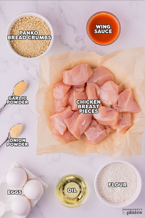 These easy boneless chicken wings are lightly breaded with panko bread crumbs and then fried - either on the stovetop or in the air fryer - until golden brown. Toss them in your favorite sauce and enjoy! | www.persnicketyplates.com Boneless Bites, Chicken Panko, Boneless Chicken Wings, Panko Chicken, Boneless Wings, Wing Sauce, Panko Bread Crumbs, Garlic Chicken, Boneless Chicken